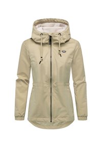 Beige lett jakke med snøring i hetten, glidelås, elastiske ermer og en litt lengre bakkant for ekstra dekning.