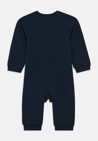 Mornarsko modra bodysuit dolgi rokavi s krožnim izrezom, izdelana iz mehkega materiala. Ima rebraste manšete in zapenjanje na dnu. Preprost dizajn.