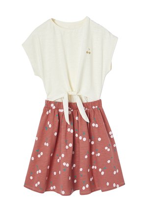 Cream short-sleeve top with front tie paired with rust-red skirt featuring white cherry patterns and green stems.