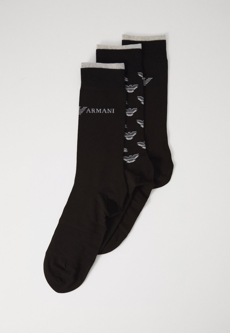 Three pairs of black socks, one with gray logo, one featuring a patterned design, and one solid. All have ribbed tops.