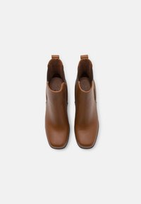 Brown leather ankle boots with a smooth finish, square toe, side elastic panels, and pull tabs on the back for easy wear.