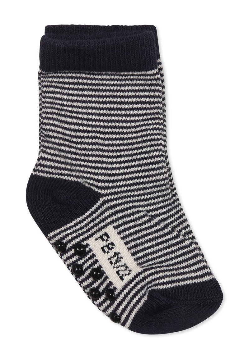 Paski skarpet w kolorze granatowym i białym, z ribbowanym mankietem, teksturowanym dnem dla lepszego chwytu oraz metką z czarnymi akcentami.