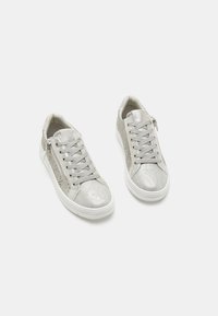 Silver sneakers with a textured finish, featuring a lace-up design, side zipper, and perforated detailing on the sides. White soles.