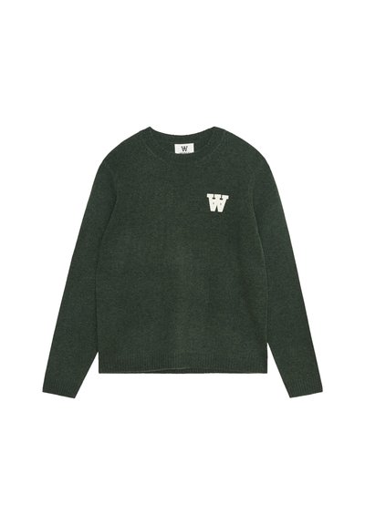 Vihreä neulepaita, jossa on pyöreä kaula-aukko, pitkät hihat ja rinnan kohdalla valkoinen "W" -logo. Ribattu helma ja hihansuukkeet.