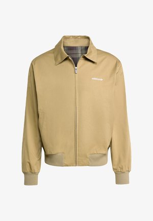 Beige Zip-Jacke mit spitzem Kragen, elastischen Bündchen und kariertem Futter. Mit einem weißen adidas-Logo auf der linken Brust.