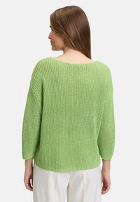 Lässig geschnittenes, grünes Strickpullover mit weitem Ausschnitt und Dreiviertelärmeln. Strukturiertes Material mit einer entspannten Silhouette.
