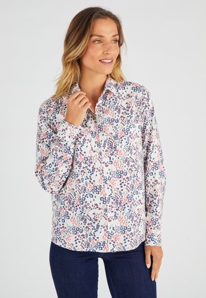 Overhemd met knopen, voorzien van een bloemenpatroon in blauw, rood en wit. Gemaakt van een lichtgewicht stof met een kraag en lange mouwen.