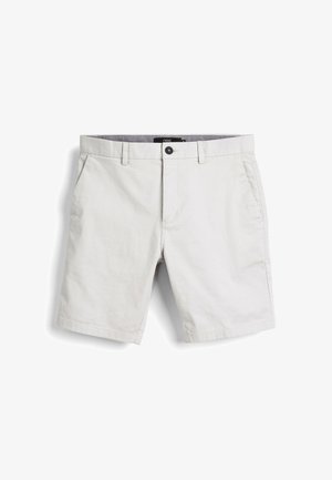 Heledad hallhalli lühikesed püksid, mis on valmistatud puuvillast. Omab eespool taskuid, ühte nööp sulgemist ja puhast viimistlust ilma mustrite või kaunistusteta.