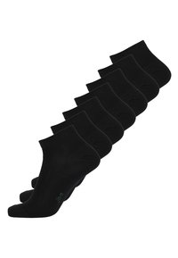 Schwarze Knöchelsocken in einer Reihe angeordnet, aus einem glatten, dehnbaren Material mit einem gerippten Bündchen. Grüner Logoakzent auf einer Socke.