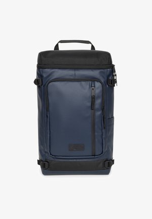 Laivastonsininen reppu mustalla yläosalla, valmistettu kestävästä kankaasta. Siinä on edessä vetoketjullinen tasku, sivutasku ja säädettävät hihnat.