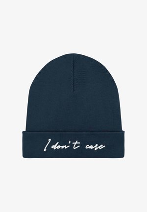 Knitted navy beanie hat featuring a folded cuff with white embroidered text reading "I don't care." Text centered on the front.