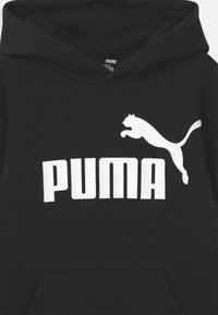 Sudadera negra de algodón con un logo blanco de PUMA y texto en el pecho. La capucha está forrada y tiene un bolsillo delantero. Diseño sencillo.