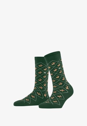 Grüne Socken mit einem all-over Rautenmuster, die kleine beigefarbene Hirschsilhouetten zeigen, mit gerippten Bündchen und einer weichen Textur.