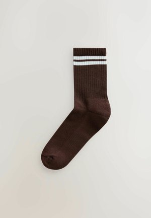 Brown cotton sock with ribbed texture, featuring two white stripes at the top. Designed for a snug fit with a rounded toe.