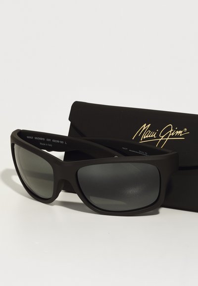 Black Maui Jim sunglasses with gray lenses, wide rectangular frames, and a matte finish, resting on a black protective case.