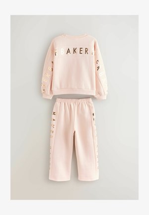 Rózsaszín pulóver és passzoló nadrág szett, puha anyagból, a hátulján és az oldalán fénylő arany színű "BAKER" felirattal. Gumírozott derék.