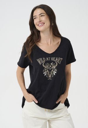 Black, short-sleeve t-shirt with a v-neck, featuring a central graphic of a bull skull adorned with flowers, and the text "WILD AT HEART" above.