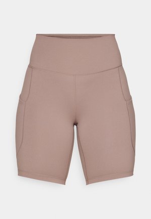 Pantaloni bici beige a vita alta realizzati in tessuto elastico, dotati di tasche laterali e cuciture piatte per il comfort.