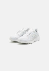 White athletic sneakers with a mesh upper, textured detailing, rounded toe, and a cushioned sole. Features laces and subtle branding accents.