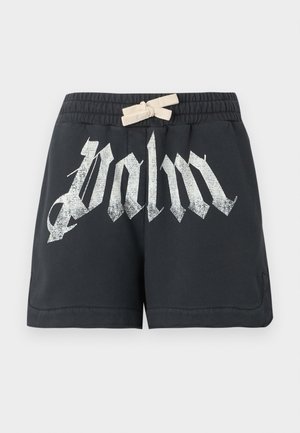 Zwarte shorts met witte trekkoord taille en grote versleten witte gotische tekst "palm" aan de voorkant.
