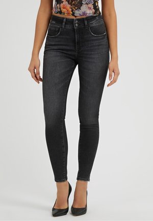 Jeans skinny negros de mezclilla, con una cintura alta, cinco bolsillos y un diseño clásico con detalles de costura mínimos.
