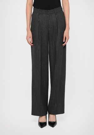 Gray, pleated wide-leg trousers with white pinstripes, made of textured material. Paired with black pointed-toe heels.