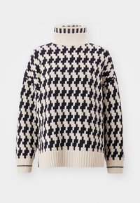 Flauschiger Strickrollkragenpullover in Creme und Schwarz, mit einem geometrischen Kreuzmuster, gerippten Bündchen und Saum.