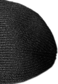 Black knitted beanie with a textured surface, rounded shape, and a snug fit. Material appears soft and elastic, suitable for cold weather.