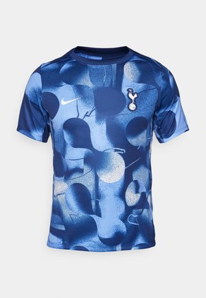 Blå grafisk t-shirt med abstrakta former i varierande nyanser av blått, med rund hals. Nike-logotyp och Tottenham Hotspur-emblem inkluderade.