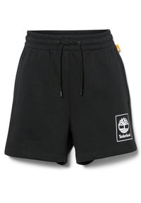 Shorts noirs en coton avec une taille élastique et un cordon de serrage. Présentent un patch logo Timberland blanc sur la jambe gauche. Texture lisse.