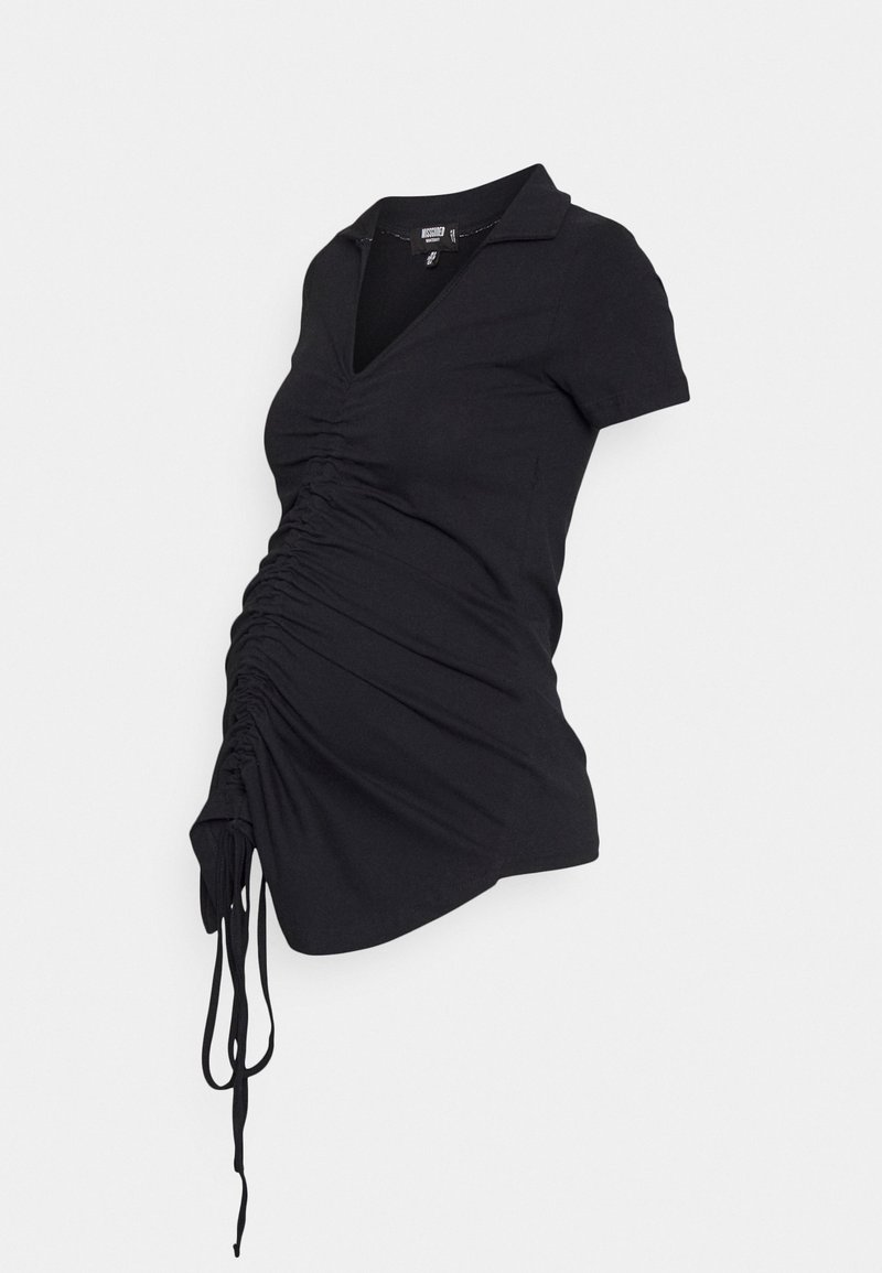 Top de maternidade preto com colarinho tipo polo, mangas curtas e detalhes franzidos na cintura, apresentando laços ajustáveis na bainha.