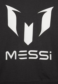 Black fabric featuring a large, white logo with sharp angles and a stylized "M." Below, the name "MESSi" appears in bold, white letters.