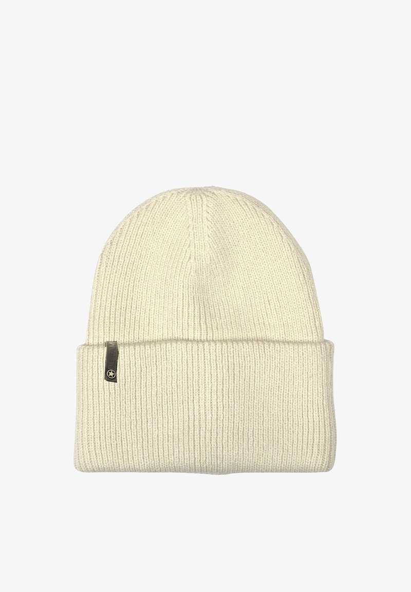 Knitted cream beanie hat with a rolled cuff, featuring vertical ribbing and a small branded tag on the side. Soft texture.