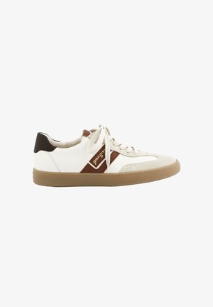 White and beige low-top sneaker with brown accents, beige laces, and gum sole, side view showing brand label on brown stripe.