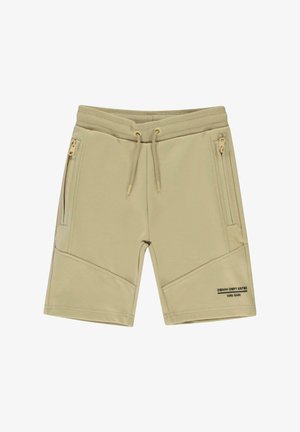 Beige shorts van zacht materiaal met een elastische tailleband, trekkoordsluiting en zijzakken met rits. Heeft schuin geplaatste naden.