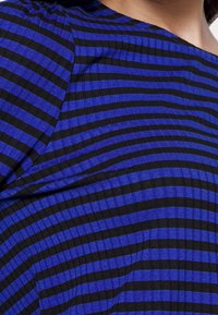 Blue and black striped fabric with a soft texture; features alternating wide and narrow stripes, creating a bold pattern.