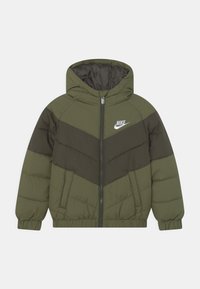 Chaqueta acolchada de Nike en verde oliva y verde oscuro con capucha, cremallera frontal, dos bolsillos, puños elásticos y logo blanco de Nike en el pecho.