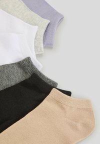 Pięć par skarpet w różnych kolorach: czarnym, beżowym, szarym, białym i lawendowym, o gładkiej fakturze i prążkowanych mankietach.