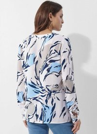 Langärmlige Bluse aus leichtem Stoff mit einem floralem Muster in Blau, Marineblau und Grautönen. Rundhalsausschnitt und Schlitzdetails an den Manschetten.