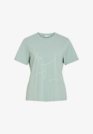 Lysegrøn t-shirt med korte ærmer med enkel hvid stregtegning af en kvindes ansigt og hals på forsiden.