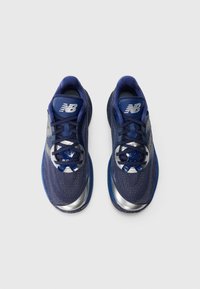 Pair of navy blue New Balance running shoes with silver accents and black laces on a white background, viewed from above.