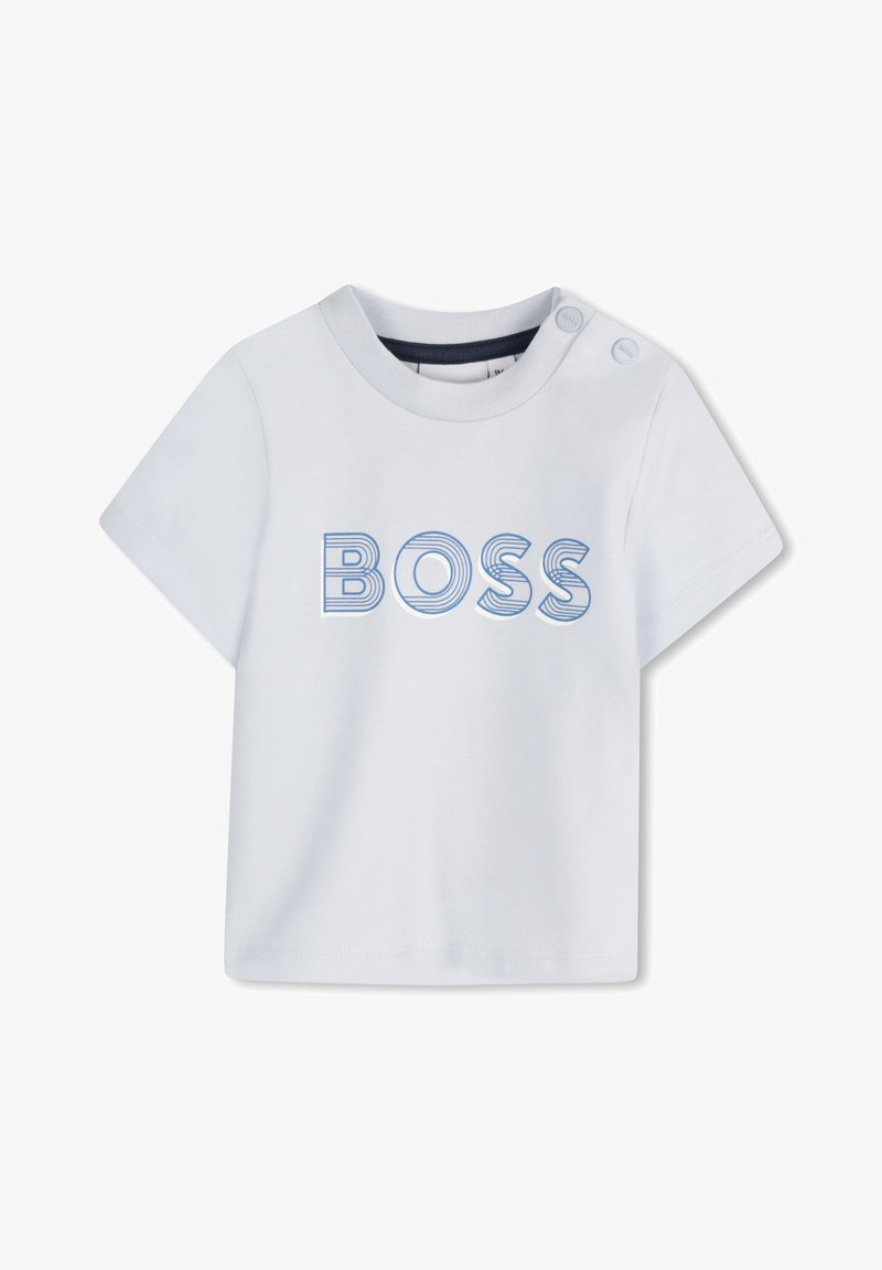 T-shirt blanc à manches courtes avec un col rond et deux boutons pressions sur l'épaule. Présente "BOSS" en lettres rayées bleues.