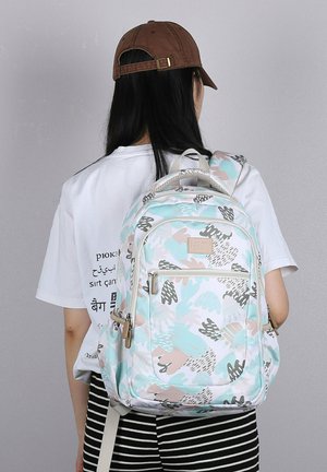 Zaino bianco con motivi astratti multicolori nei toni del blu pastello, rosa e grigio. Presenta spallacci regolabili e una tasca frontale con zip.