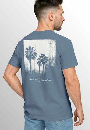 Blue cotton t-shirt featuring a palm tree graphic and text on the back. Short sleeves, crew neck, and relaxed fit.