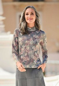 Langarmshirt mit hohem Kragen, das ein florales Muster in sanften Rosa-, Blau- und Grüntönen zeigt. Glattes Material mit einer figurbetonten Silhouette.