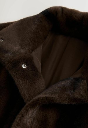 Brown faux fur coat interior featuring a soft texture, smooth brown lining, and silver snap closures. Accents include dark fur patterning.