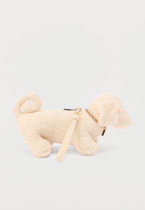 Cream-colored plush dog figure with a curly tail, golden chain collar, and a small pearl accent. Features a removable strap for carrying.