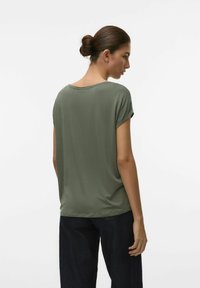 Olivegrünes T-Shirt mit kurzen Ärmeln, rundem Ausschnitt und lockerer Passform. Glattes Material; von hinten mit dunklen Jeans präsentiert.