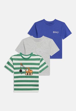 Trois t-shirts manches courtes pour enfants : rayures vertes et blanches avec un motif de grue, gris clair uni, et bleu uni avec le texte "BANG!".
