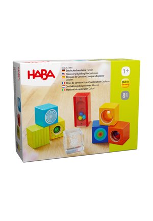 Building blocks set in vibrant colors: red, yellow, green, and blue. Includes textured and clear blocks with patterns and translucent sections.
